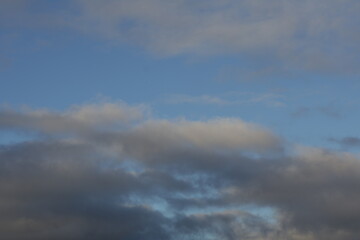 Una toma de cerca de un bello cielo con varias nubes entre colores blanco y gris