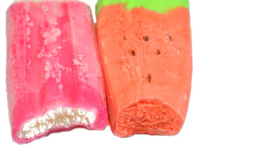 ice cream bars of watermelon and strawberry milk made of fruit shape and flavor, ice cream bar is a frozen dessert featuring ice cream on a stick, and fruit flavors mixture ice cream