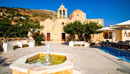 Courtyards of a traditional village with a fountain and a church.