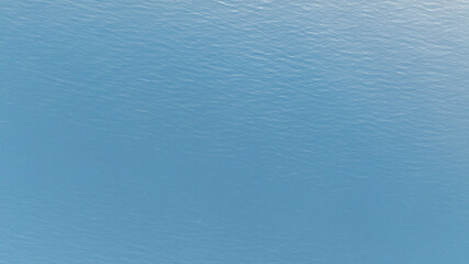 Tranquil blue waters of the Aegean sea gently ripple under the summer sun, creating a serene seascape near Kassandra, Greece