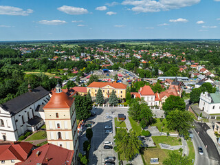 Naklejka premium Drone view of Lezajsk City Days celebration with concerts, stage lights, illumination, attractions for children and crowds enjoying music and summer festivities. City days celebration in Poland.