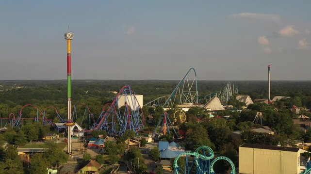 Aerial view of the thrilling roller coasters and colorful attractions of Kings Island amusement park nestled amidst lush greenery, Mason, Ohio, United States.