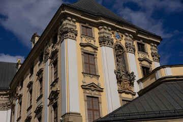 Historic baroque architecture of university building in Wroclaw, Poland, with detailed sculptures, ornate windows and decorative facade under blue sky. Cultural heritage, history and education