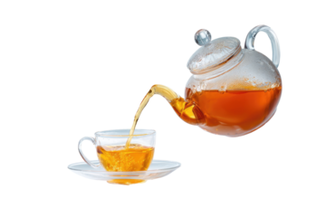 Transparent glass teapot pouring tea into a teacup