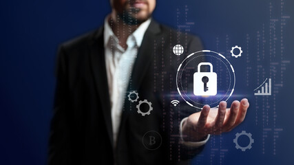 Modern cybersecurity concept with a businessman presenting a digital lock symbol in a high-tech environment