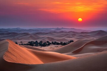 Sunrise over a desert landscape of rolling sand dunes