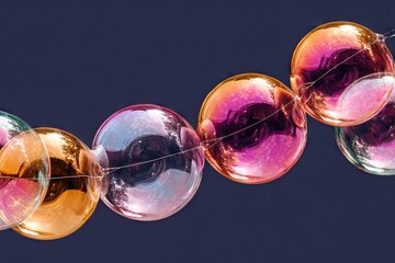 Colorful iridescent spheres strung in a curved line against a dark background
