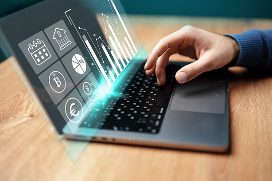 Analyzing financial data on a laptop with graphs and currency symbols displayed