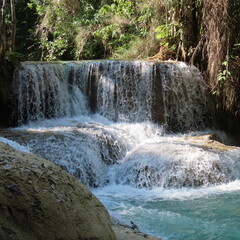 romantic small waterfall with turquoise colors in beautiful tropical nature