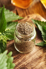 Dried stinging nettle seeds in a glass jar