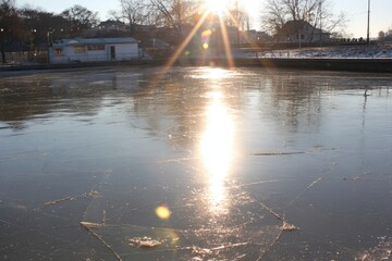 Frozen canal reflecting winter sun