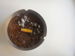 cigarette in ashtray isolated white background 