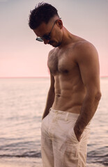 Sporty sexy guy on the beach