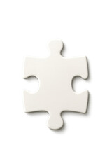 Obraz premium White puzzle piece placed on a clean surface ready to complete a larger design