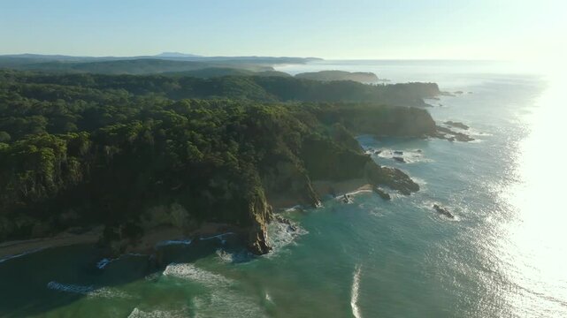 Aerial: drone shot of the Sapphire coastline on a sunny day near Tathra, NSW, Australia
