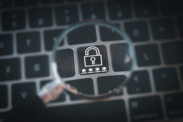 A magnifying glass over a keyboard focuses on a padlock icon. A concept for cybersecurity, internet security, data protection, and online privacy. A symbol of safe network access.