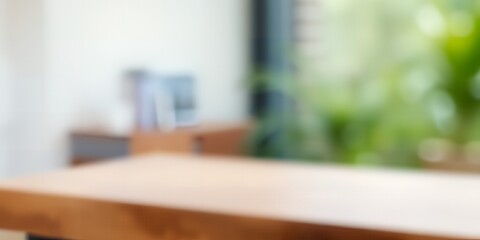Soft focus image of a wooden table in front of a blurred background with greenery