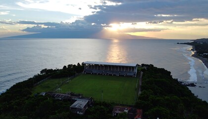 Aerial view of a stadium on a coastal headland at sunset