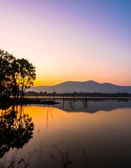 Obraz premium Sunrise over tranquil lake, silhouette trees
