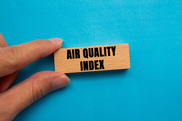 Air Quality Index message written on wooden block on blue background. Conceptual Air Quality Index symbol. Copy space.