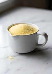 Fresh couscous in a white mug, perfect for cooking delicious meals with healthy ingredients