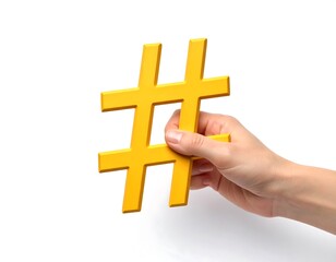 Fototapeta premium Empowering digital connections: A hand holding a vibrant yellow hashtag symbol