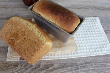 fresh, still hot bread baked at home with your own hands and cooling on the table