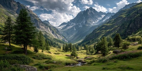 Fototapeta premium Alpine valley bathed in sunlight. Lush green meadows, towering peaks, and clouds