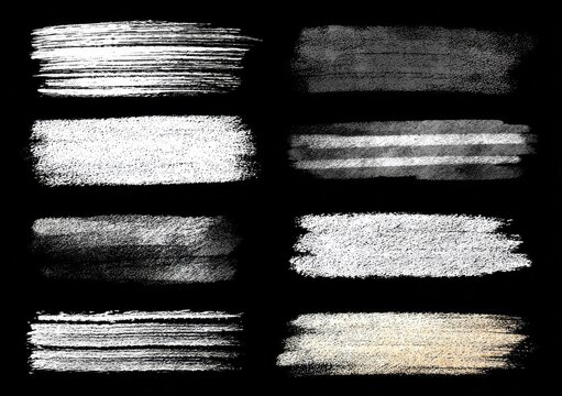 Nine textured brush strokes in shades of gray and white on a black background - Powered by Adobe