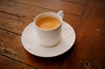 cup of coffee on wooden table