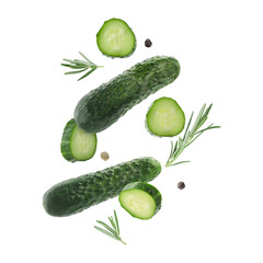 Fresh cucumbers and rosemary falling against white background