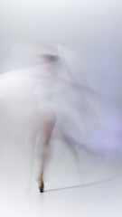 Abstract motion blur of ballerina dancing in flowing movement. Concept of creativity, art expression, inner power, mindfulness, and modern aesthetic in performing arts. © master1305