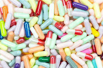 Medicine capsules with colorful pills for healthcare, pharmacy, and supplement concept.