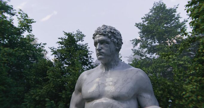 A Stunning Dynamic Sculpture Depicting a Powerful Athlete Amidst a Lush Park Environment