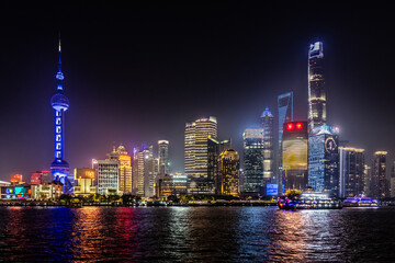 Night time waterfront cityscape of Pudong in Shanghai, a business district next to Huangpo river in China
