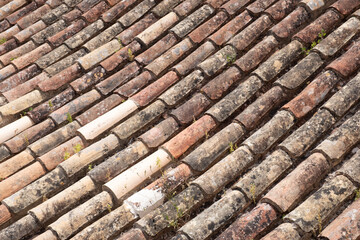 Old and worn terracotta roof tiles in Portugal