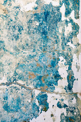 Stained and worn concrete with fading blue paint