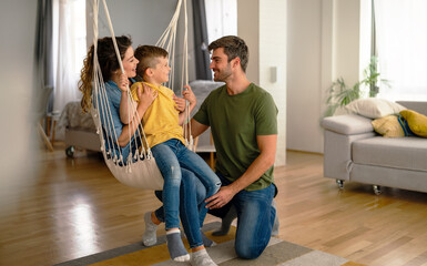 Happy family leisure. Cheerful mother, father and son having fun together on weekend at home