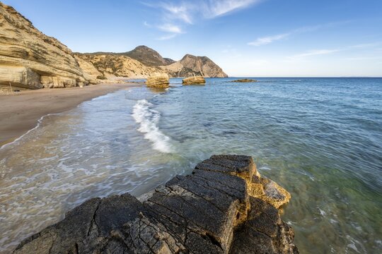 Waves crashing against rocks, sandy beach with rocky cliffs, Paralia Paradisos, Kos, Dodecanese, Greece