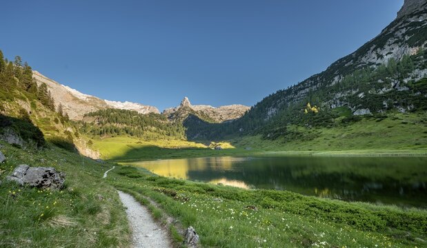 Path around the lake Funtensee, Schottmalhorn reflected in the Funtensee, Steinernes Meer, Berchtesgaden National Park, Bavaria, Germany