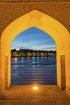 View through bridge arch, Si-o-se Pol Bridge or Allah-Verdi Khan Bridge at dusk, Esfahan, Iran