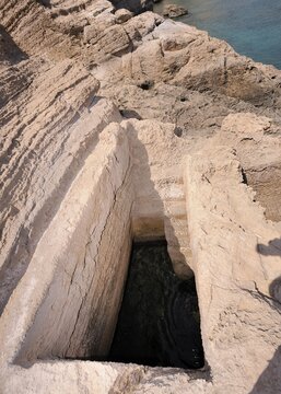 Pool carved rock with underground connection to the sea, perhaps used as a fish tank, Cape Fourni, Rhodes, Greece, Europe