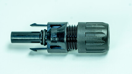 Close up of single MC4 solar connector on white background
