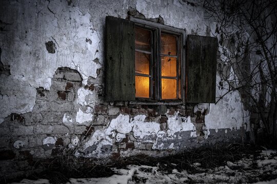 Old decayed wooden window on old house facade in candlelight, Mindelheim, Unterallg&auml;u, Bavaria, Germany