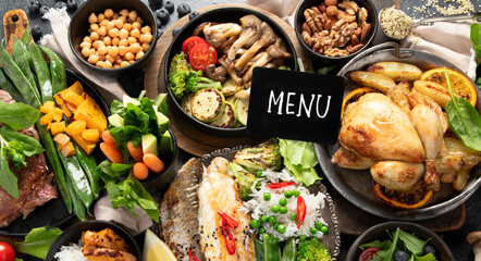 Table scene of various delicious foods. Healthy, family dinner.