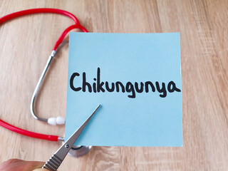 Chikungunya text, word Chikungunya note in tweezers on a stethoscope background, virus, treatment, medical concept.