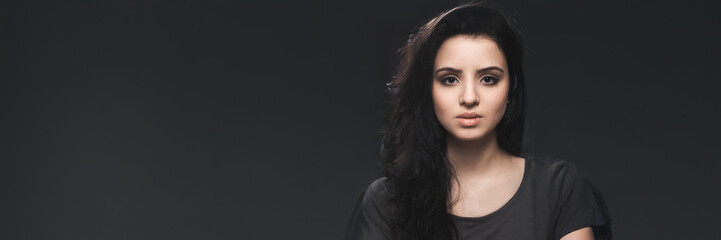 Naklejka premium Woman with Neutral Expression on Dark Wide Banner