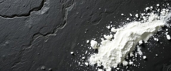 Obraz premium Dark stone backdrop, dusted with white flour, showing texture, texture, rustic