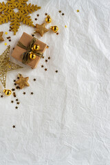 Gold Christmas theme decorations on paper texture background,  Christmas tree, gold presents box, decorative gold stars and gold gift box.