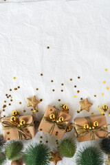 Gold Christmas theme decorations on paper texture background,  Christmas tree, gold presents box, decorative gold stars and Christmas ball. 